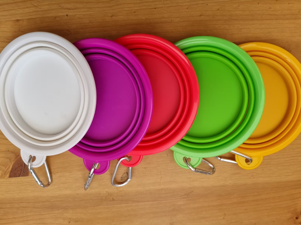 Collapsible silicone dog water bowl with fast clip - folds flat attaches to training vest belt or bag holds 300ml approximately half a pint enough for a working Cocker between exercises soft safe and easy to clean available in orange white and yellow as stocked at Kirkbourne Spaniels