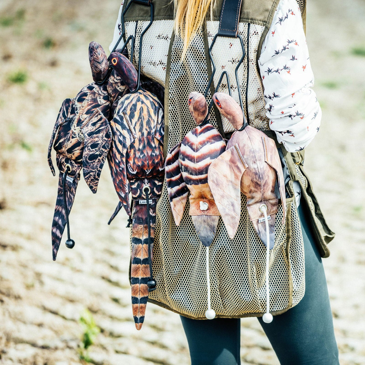 Dog & Field Original Clone hen pheasant dead bird dummy in bird carrier alongside real game birds - scent retaining real-feel material absorbs natural game scent for advanced gundog retrieve training and shooting day preparation